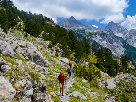 Hikers on a trail in the Albanian Alps, Peaks of the Balkans route.