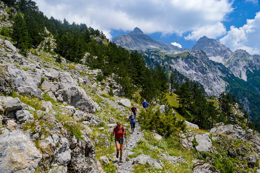 Hikers on a trail in the Albanian Alps, Peaks of the Balkans route.