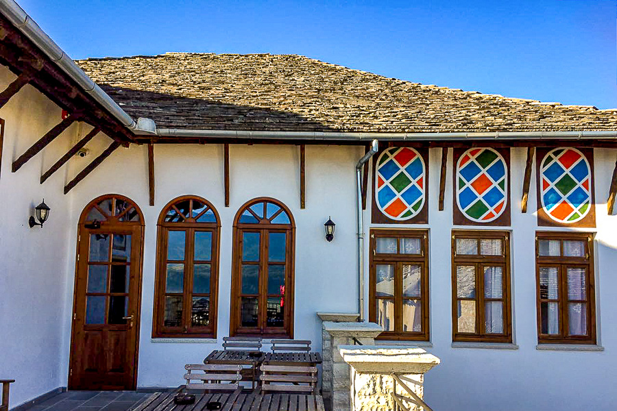 Traditional Gjirokastër house facade with wooden windows